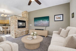 Room is virtually staged. Family room has double sided gas fireplace surrounded by stacked stone