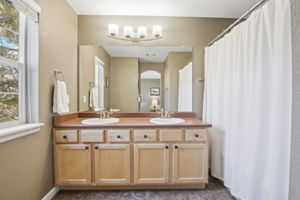 Spacious primary bathroom with double vanity sinks