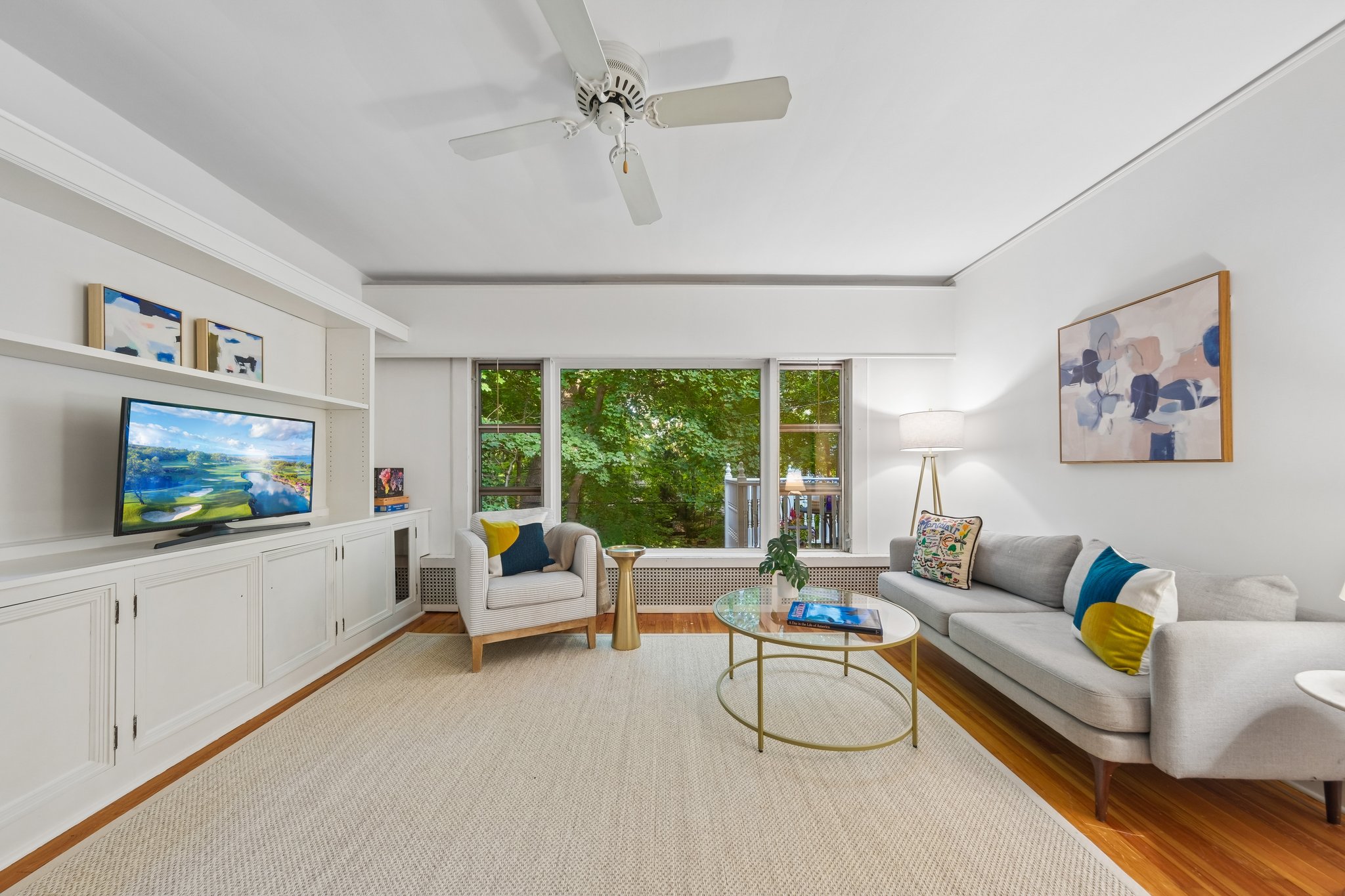 MOVIE NIGHT, MEET WOODLAND VIEWS. Built-ins anchor the family room, while broad windows bring the trees into the picture. Choose the screen or the scenery.