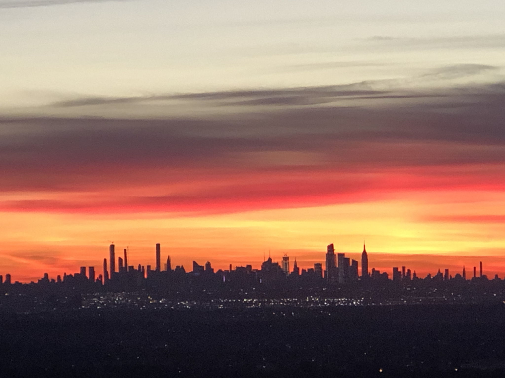 CITY PLANS? YOU’RE CONNECTED. Manhattan is just 13 miles away, with train and bus options nearby. Routes 3 and 46 and the Garden State Parkway make trips beyond town easy. Regional skyline photograph; not a view from the property.