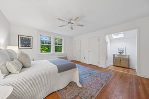 TUCKED INTO THE TREETOPS. Leafy windows and a tucked-away nook give this upstairs bedroom its own gentle rhythm. Sleep, read, recharge.