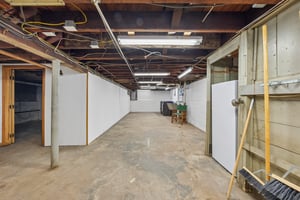 BRING YOUR IDEAS DOWNSTAIRS. A large unfinished basement offers a blank canvas for whatever you're dreaming up, with room to organize tools, supplies and hobbies.
