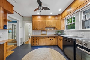 BRING HOME SOMETHING DELICIOUS. Warm wood cabinetry and windows above the counter set the scene for unpacking your market finds and deciding what's for dinner.