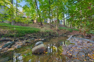 THE SOUNDTRACK IS ALREADY HERE. Well below the house, the Second River meanders through the woods, bringing the gentle sound of moving water to your backyard retreat. Pull up a chair. Let the day slow down. This home is NOT in a flood zone and flood insurance is NOT required.
