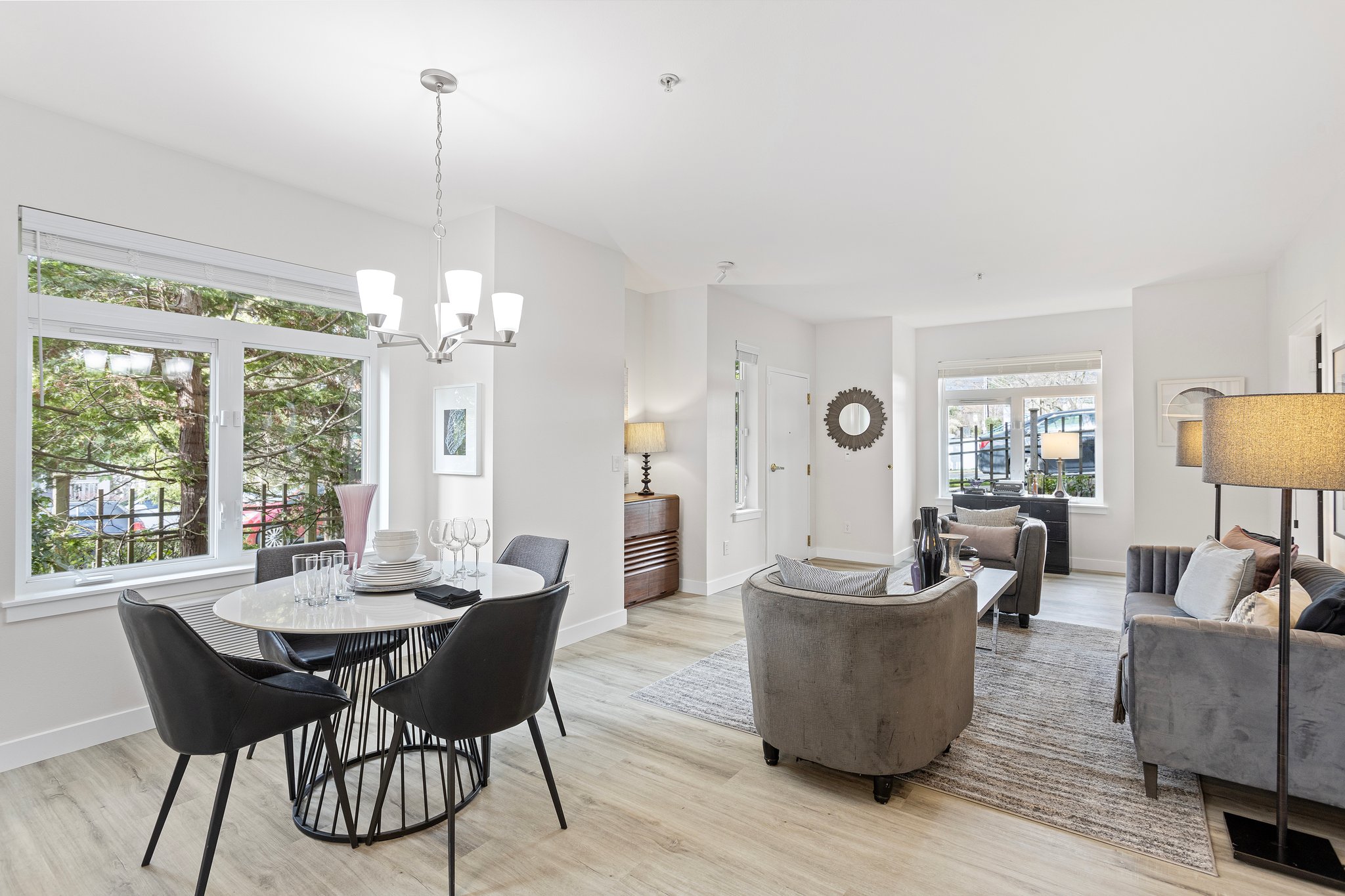 Delight in the expansive living room that gracefully flows into the dining area, where west-facing windows invite an abundance of evening light, setting the stage for memorable moments and cozy twilight gatherings.
