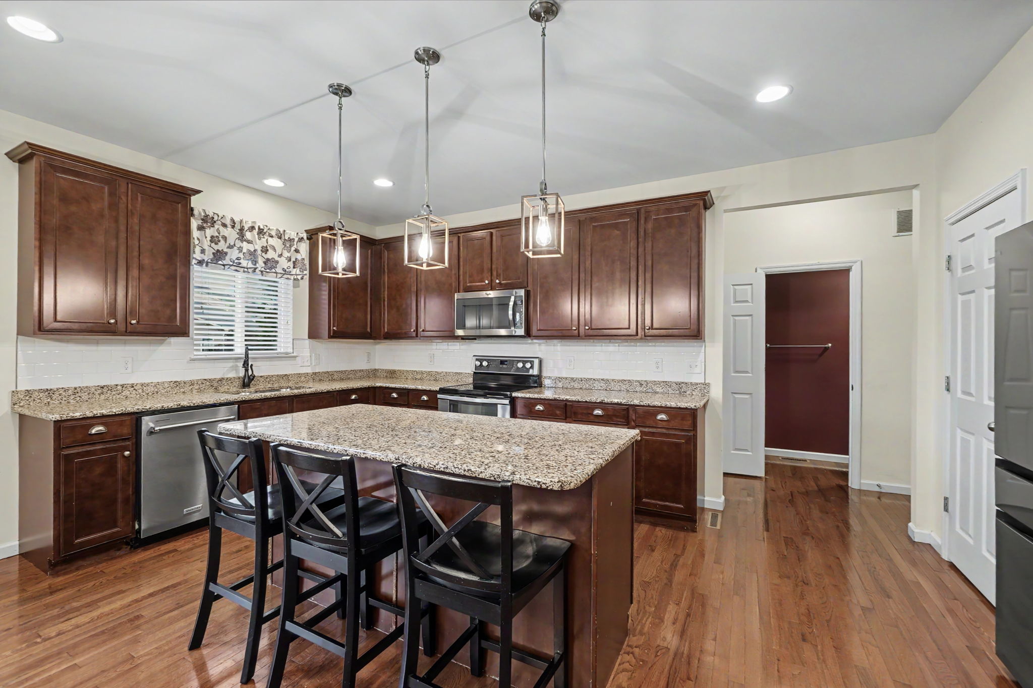 Kitchen features center island and granite countertops