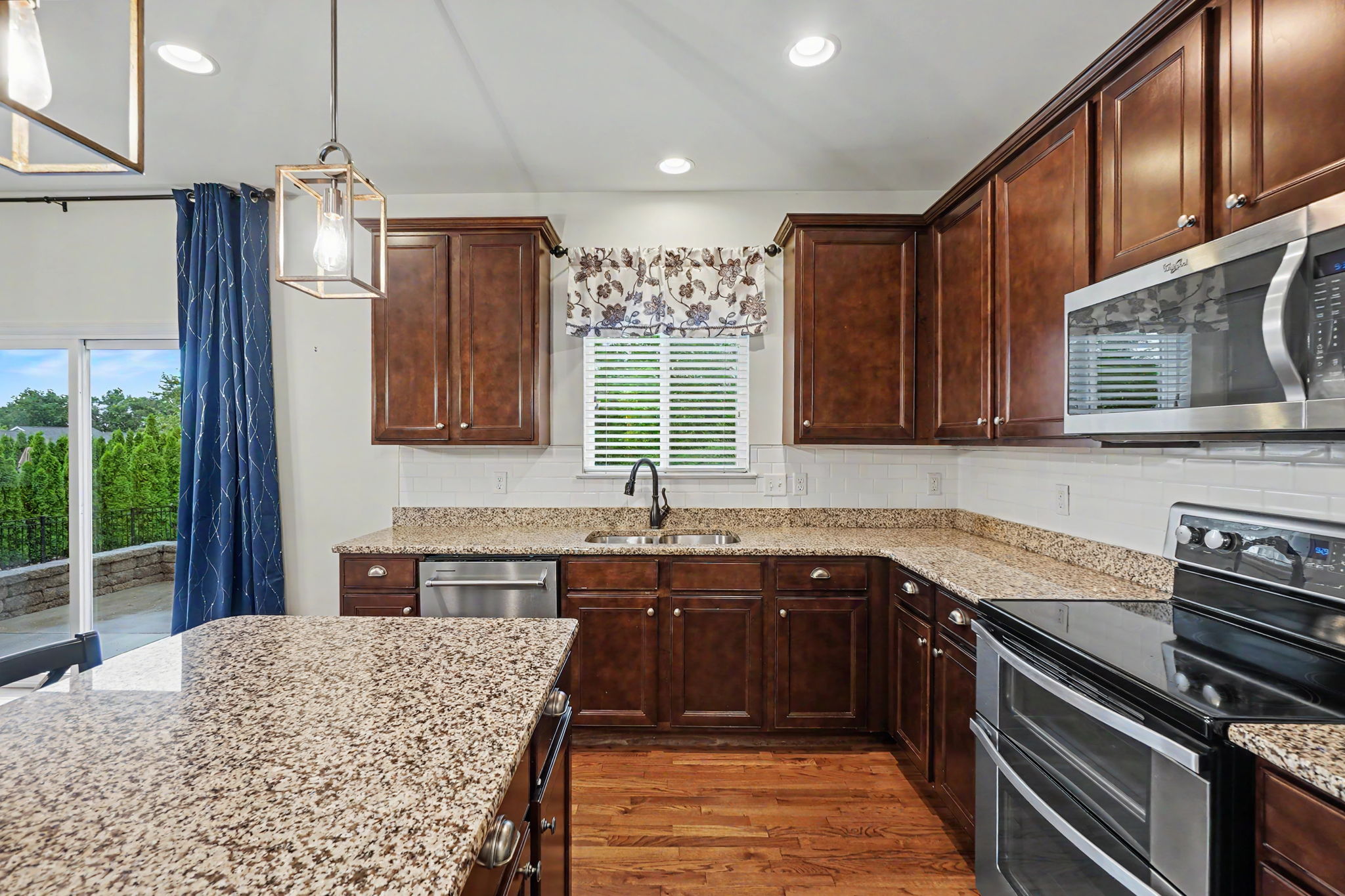 Tiled backsplash, upgraded cabinetry, and stainless appliances.