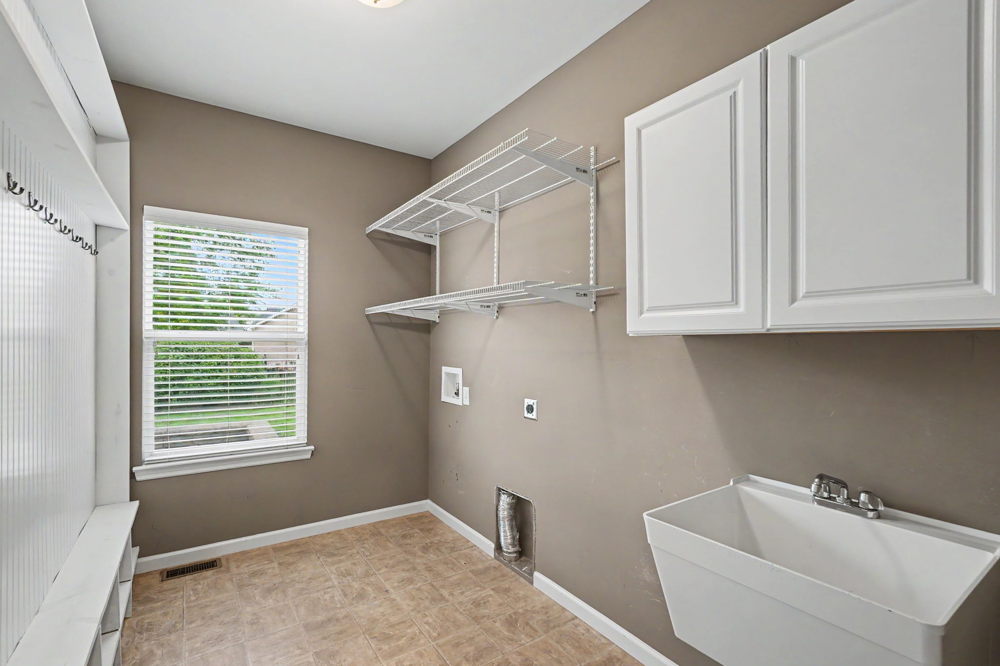 Main floor laundry with sink and cubby area