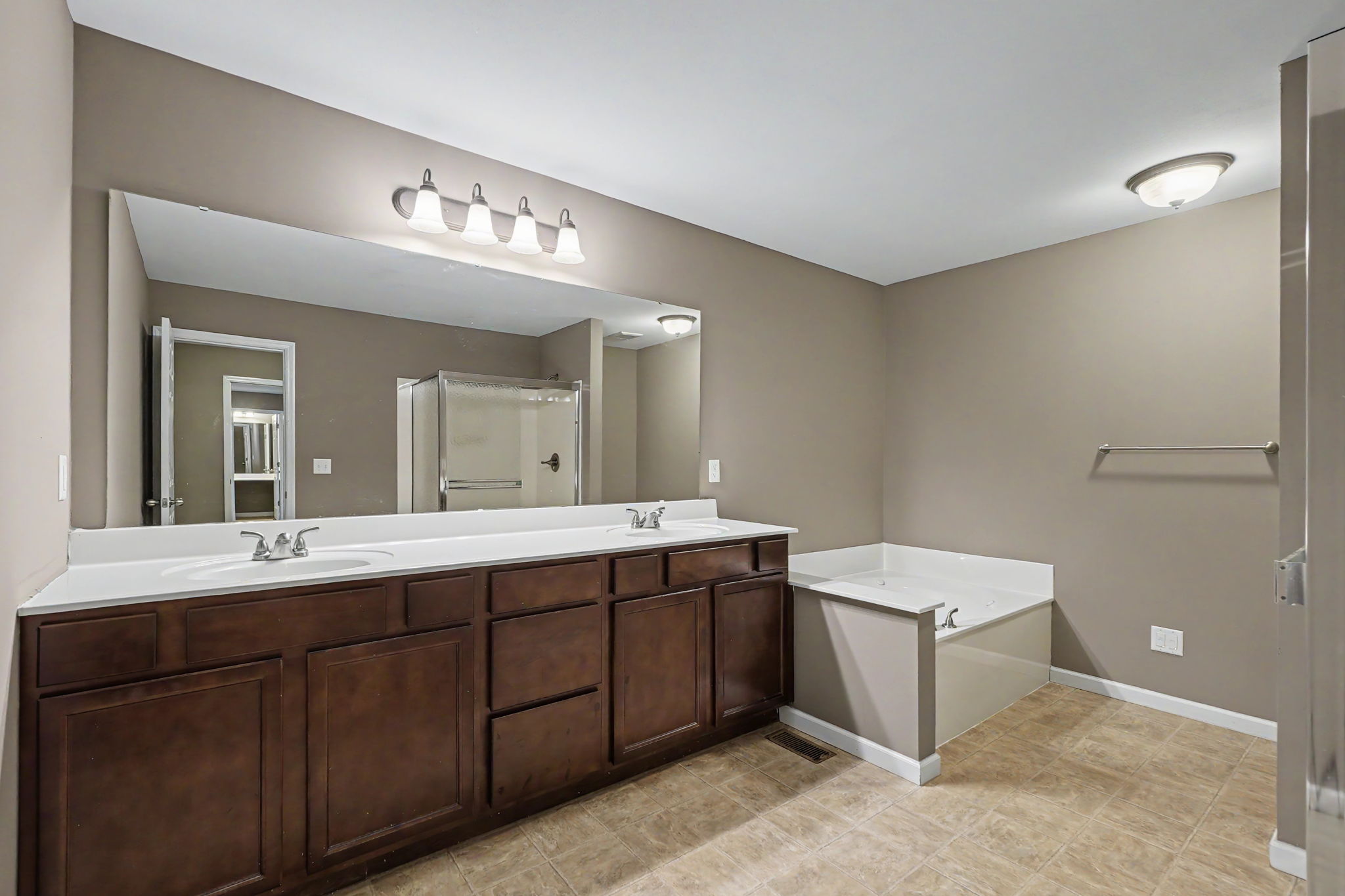 Private bath with double vanity, jetted tub, and shower
