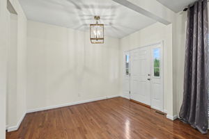 Formal entry foyer showcases 10 ft ceilings and hardwood floors throughout!