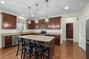 Kitchen features center island and granite countertops
