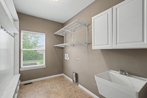 Main floor laundry with sink and cubby area