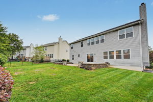 Great backyard enclosed by wrought iron fencing.