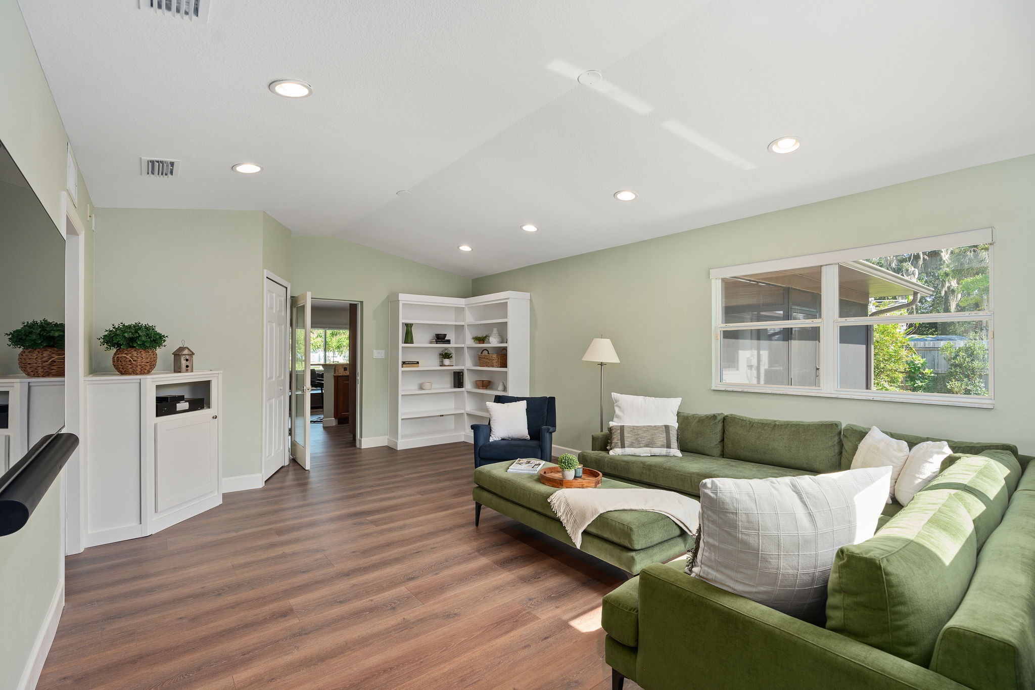 Family room built-ins like corner book shelves, media cabinet and linen closet