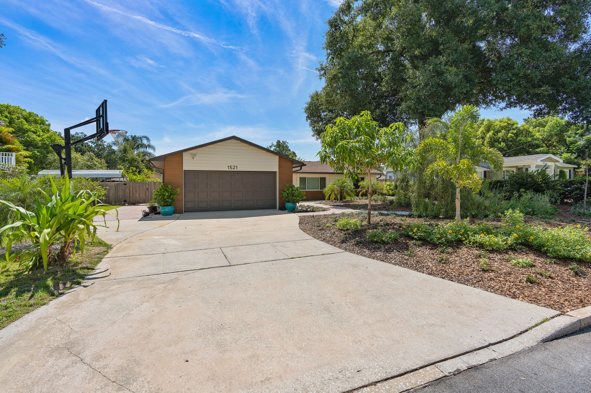 2 car garage with wide long driveway plus added brick paver parking for additional cars or recreational items