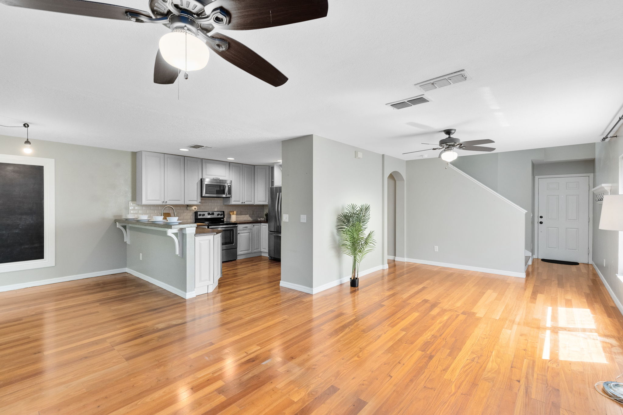Living Room with View to Dining Room & Kitchen