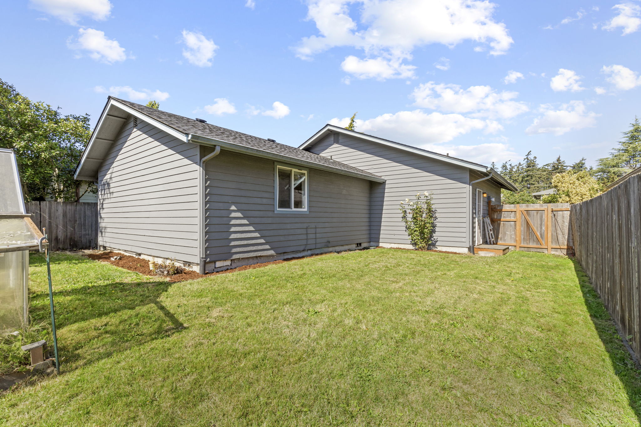 fully-fenced, spacious back and side yard