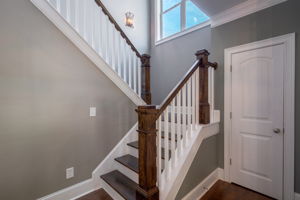 Wood stairs to second floor & coat closet