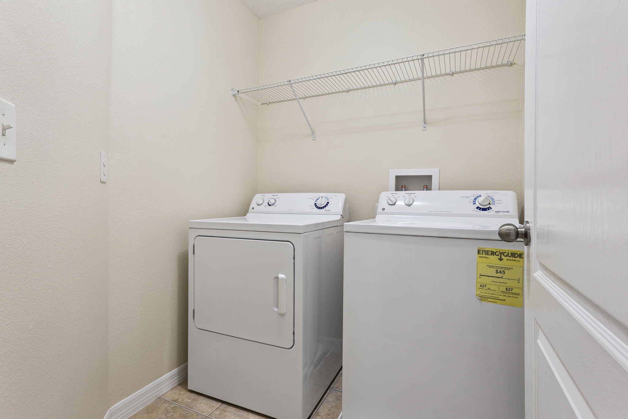 upstairs laundry room including washer and dryer