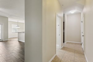 hallway towars half bath, large storage closet, kitchen entrand and garage