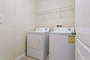 upstairs laundry room including washer and dryer