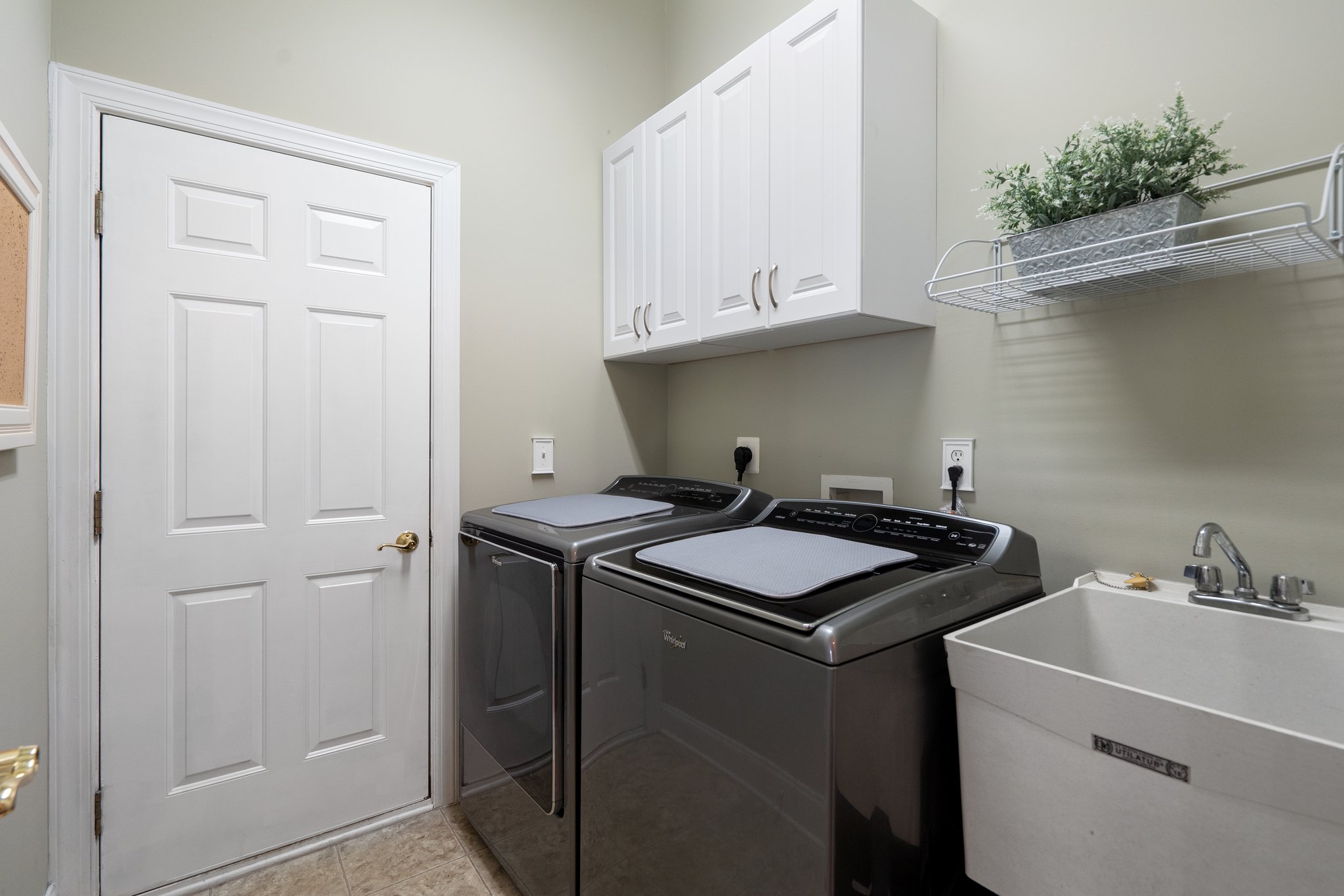 Separate Laundry with Cabinets and Sink