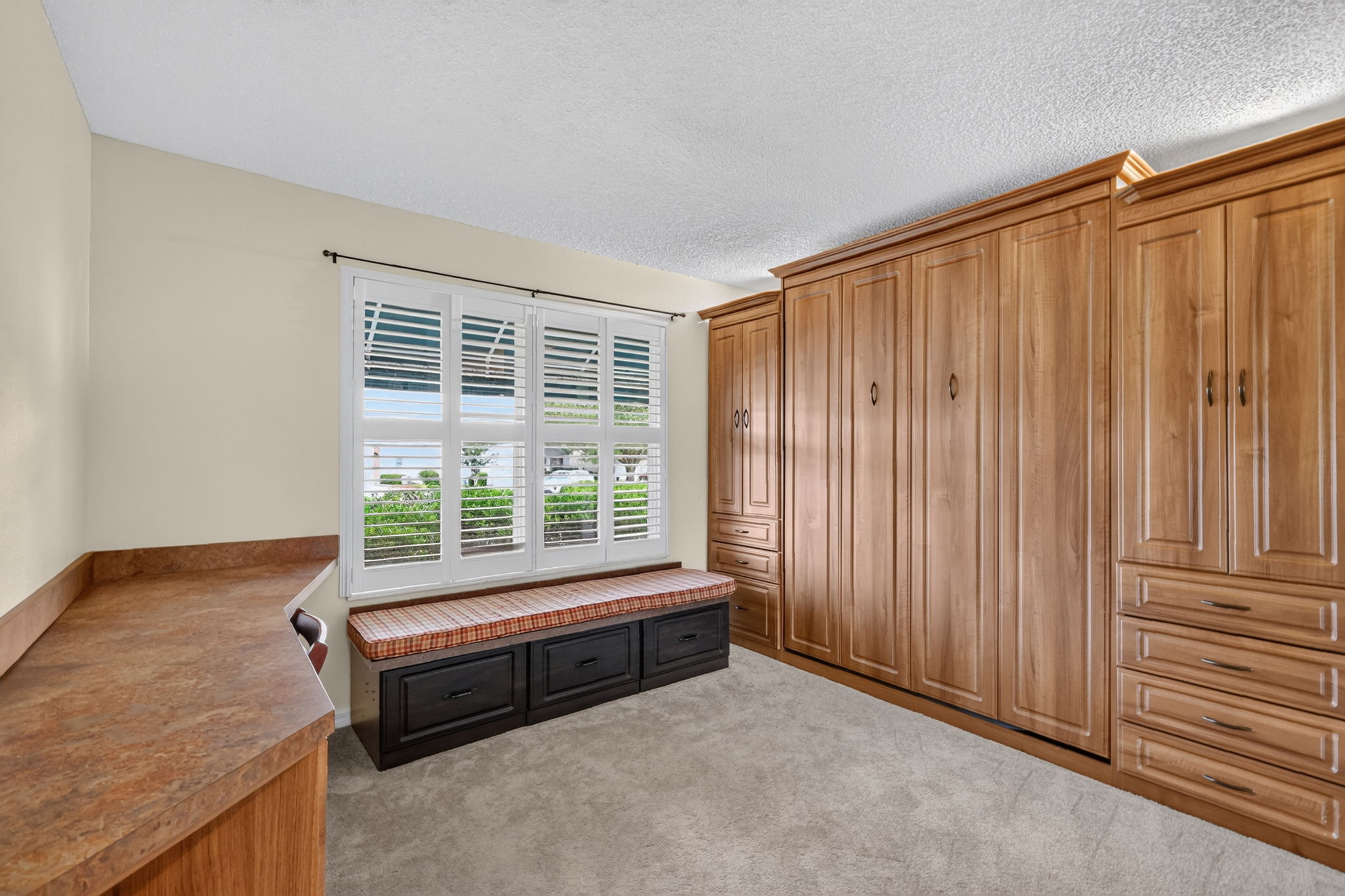 Second Bedroom with Murphy Bed, Built-In Desk, and Bench