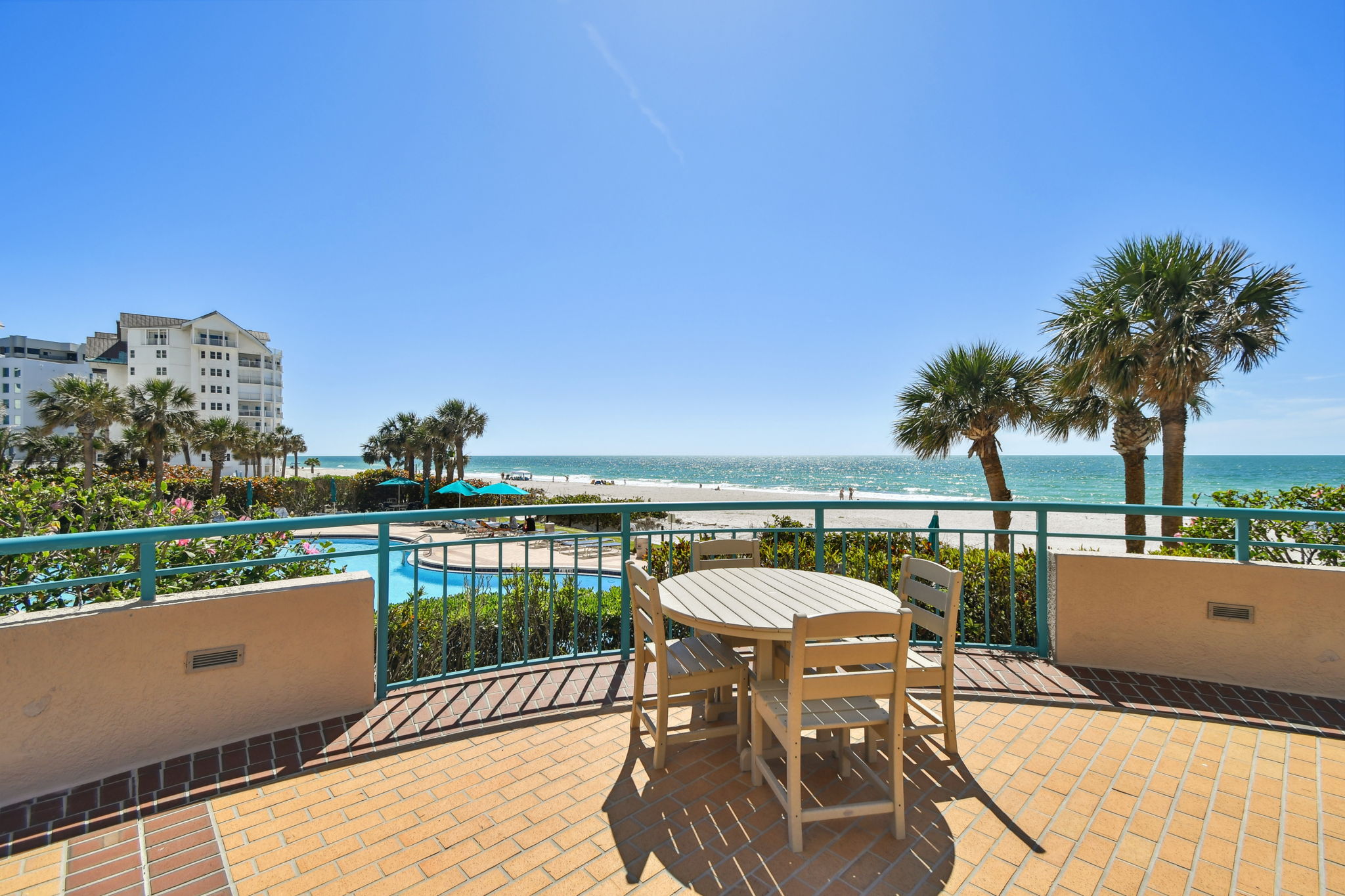 Common Area Exterior Patio Featuring Dining Table Overlooking South Pool & Water Views
