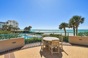 Common Area Exterior Patio Featuring Dining Table Overlooking South Pool & Water Views