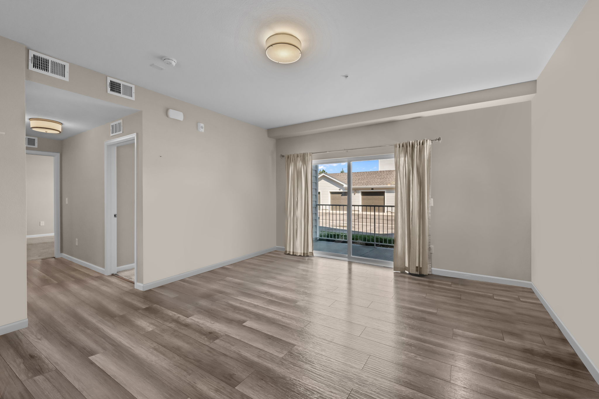 Family room with oversized sliding door out to covered patio