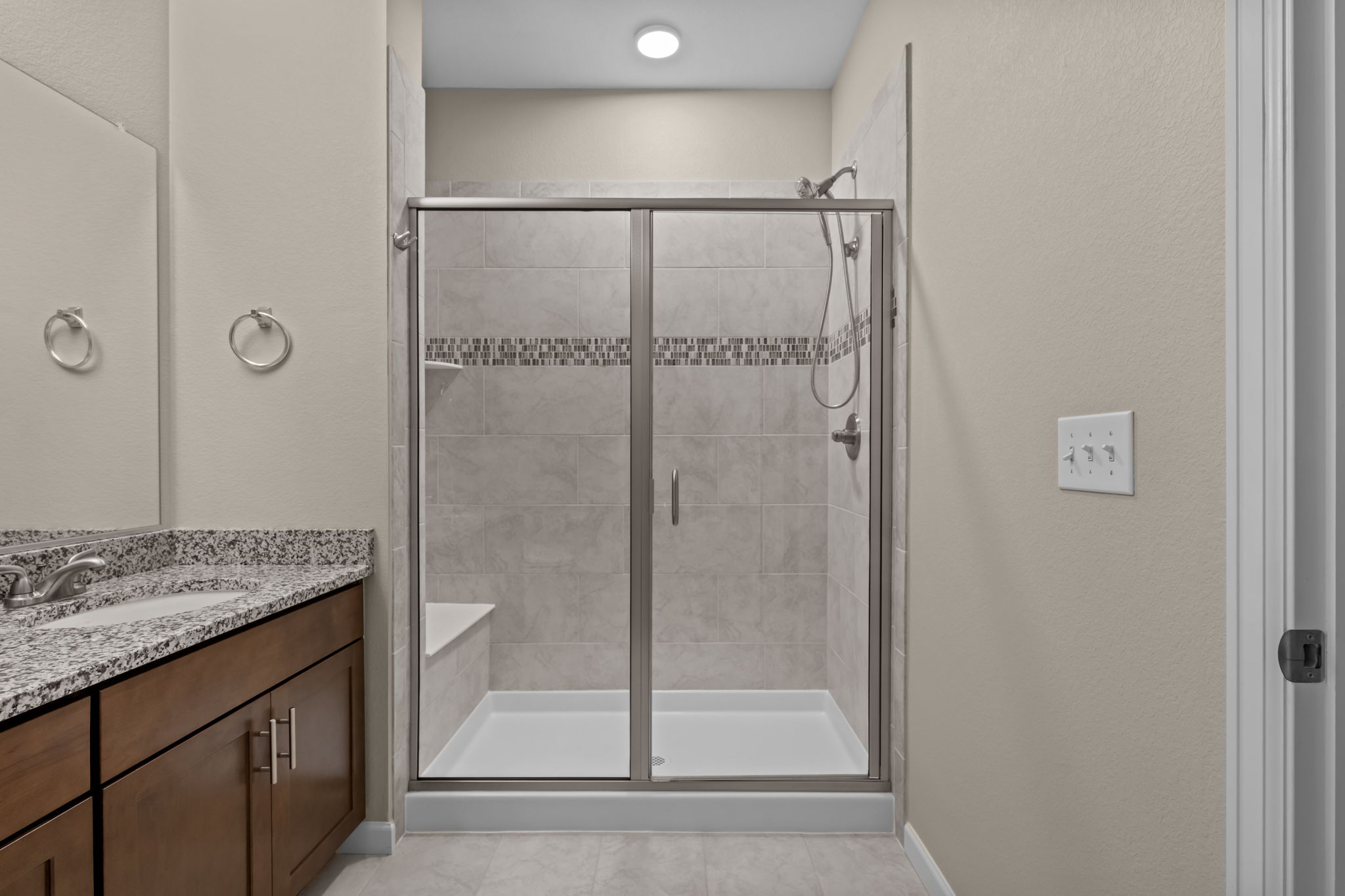 Primary Bathroom & shower with built in seat, ceramic tile accent