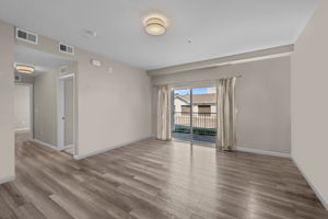 Family room with oversized sliding door out to covered patio