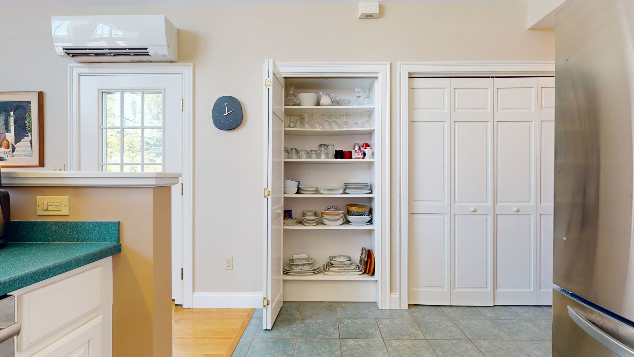 Stairway to 2nd level behind pantry shelves