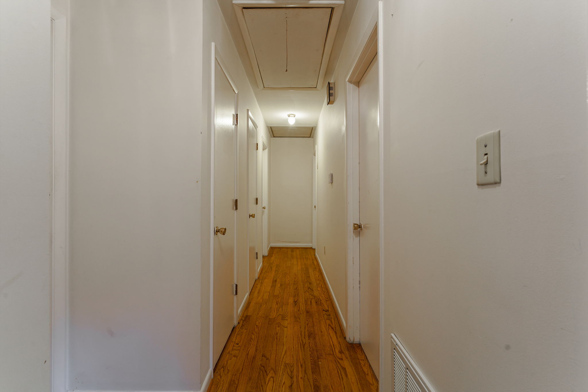 Hallway to Bedrooms w/ Hardwood Floors