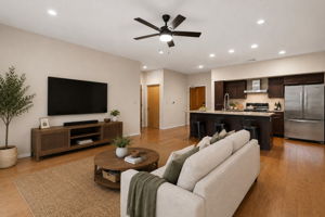 Wood flooring throughout entry, kitchen and living areas.
