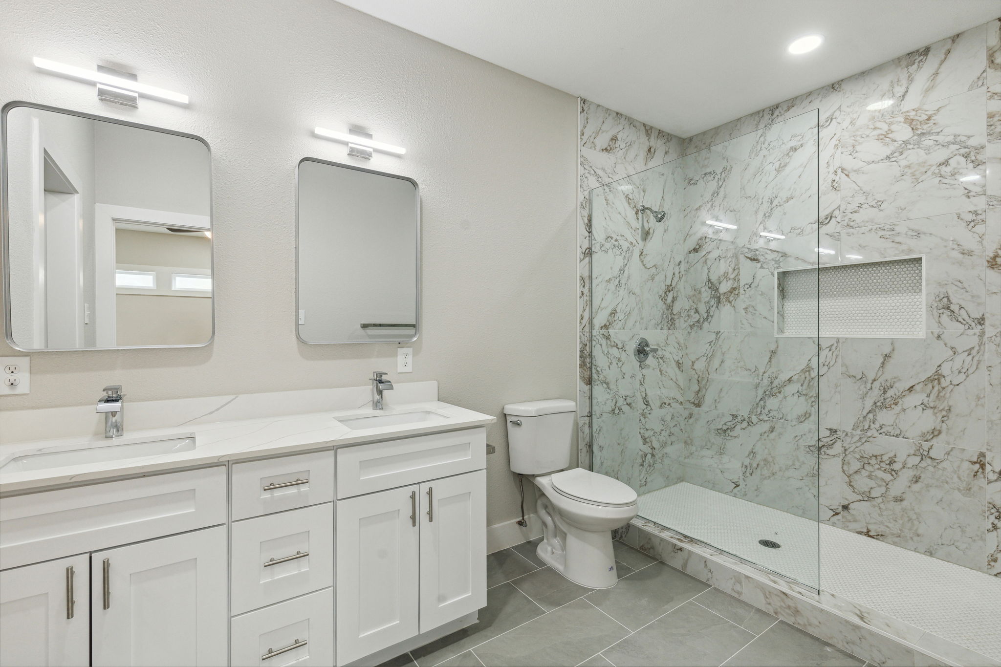 Primary bathroom with large walkin shower and closet.