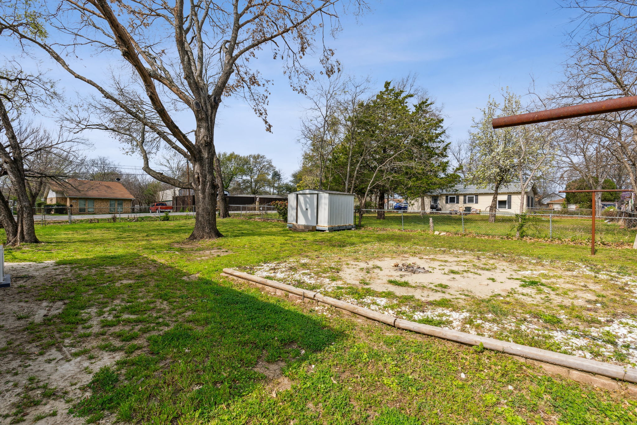 Large fenced backyard with additional gated entry to park cars, work trailers, or boats.
