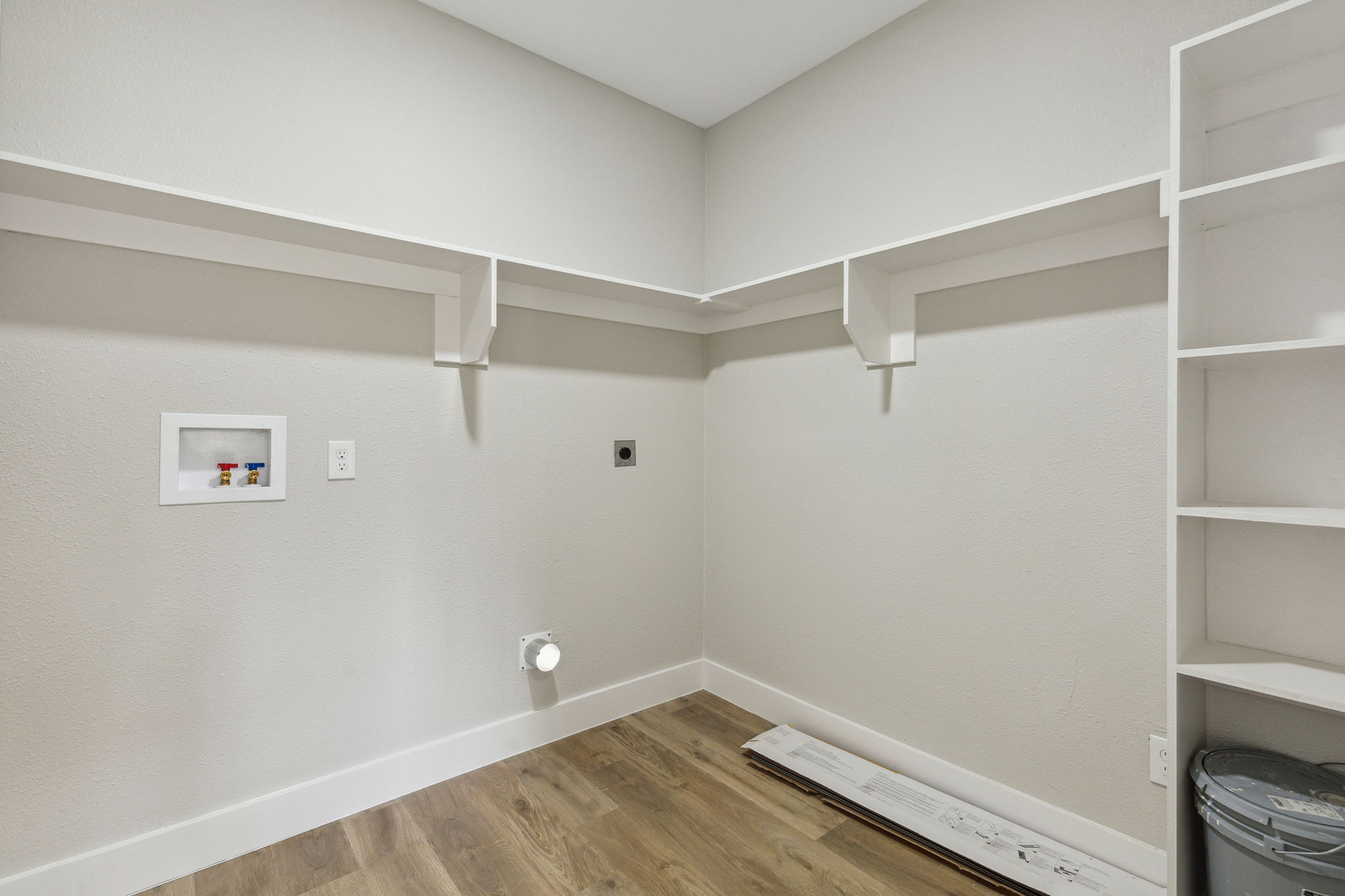 Large utility room with builtin shelves for additional storage and usability