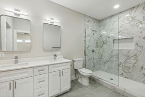 Primary bathroom with large walkin shower and closet.