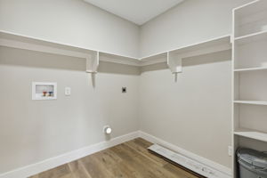 Large utility room with builtin shelves for additional storage and usability