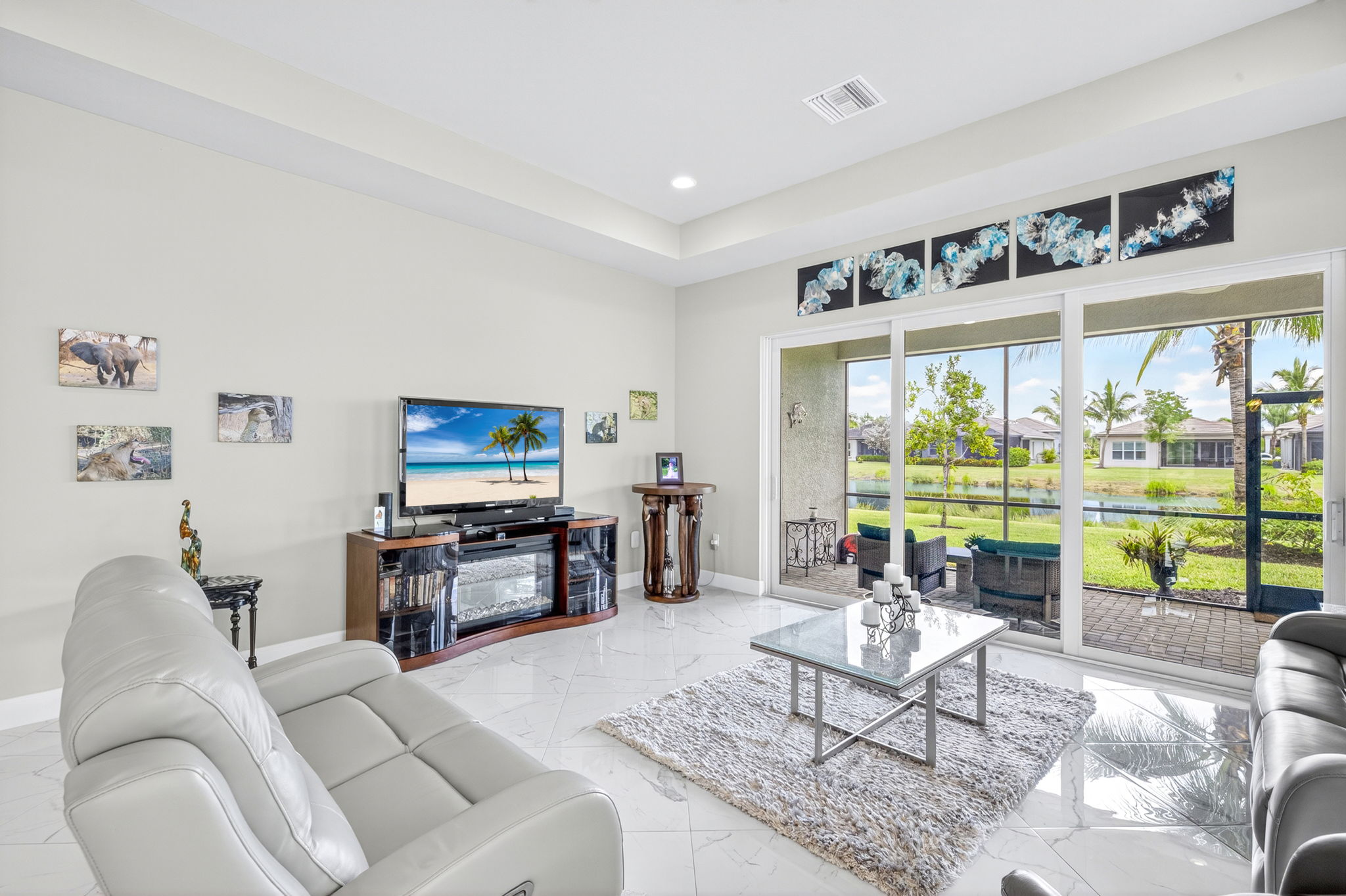 Living room view with sliders to outside screened lanai.