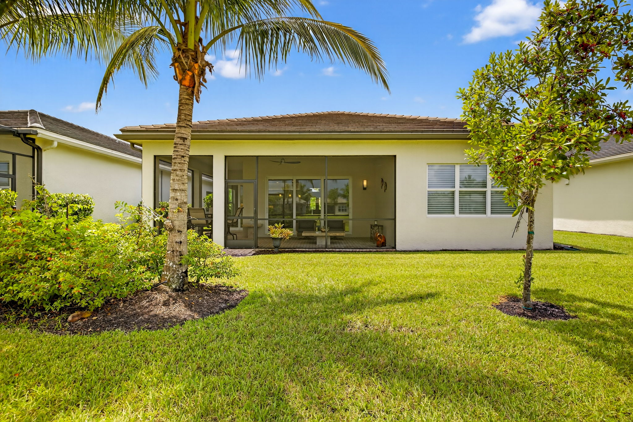 TL-shaped screened lanai area...The triple windows are the primary bedroom windows!