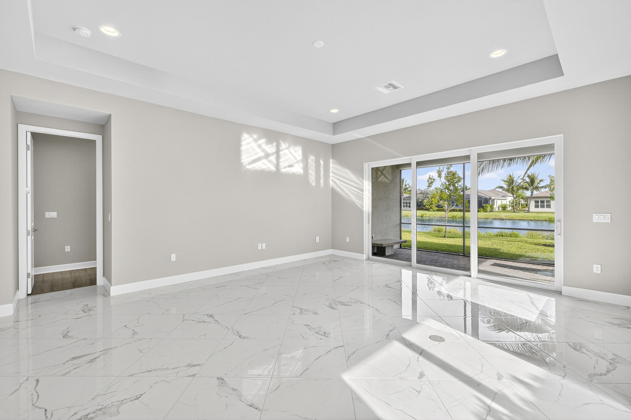 The heart of the home! This great room is spacious and features a tray ceiling and entrance to the primary suite...