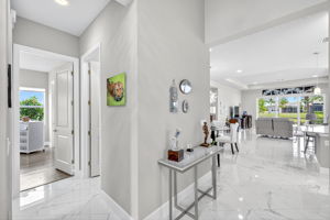 Entry foyer showing openness to living room and guest bedroom.