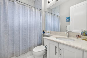 THIRD full bath!!! Banjo countertop is an upgrade, as is floor to ceiling tile in the bath. This is located between the den and 3rd bedroom.