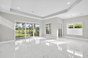 Great room and breakfast area both open to a covered lanai area with lake view.