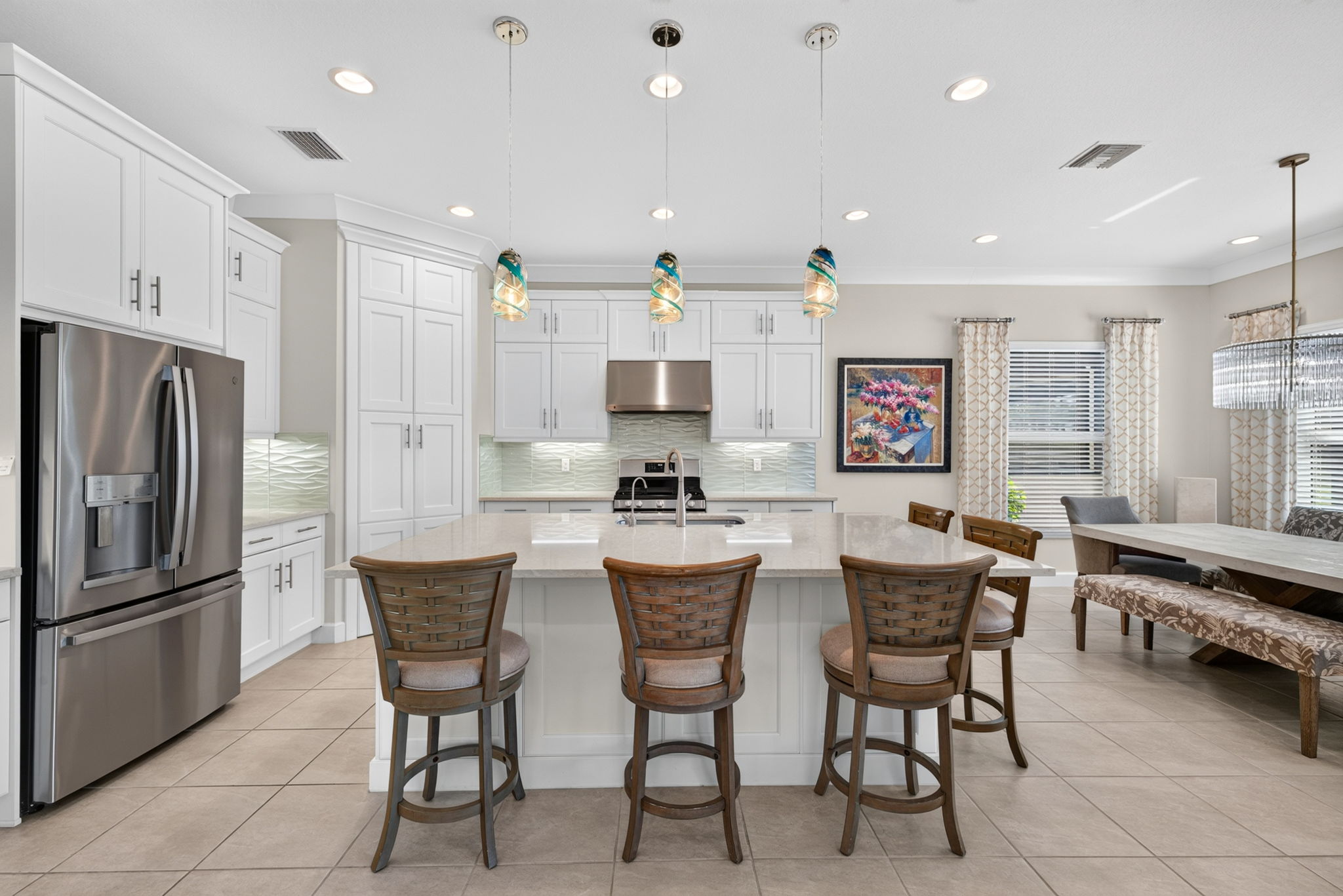 Quartz countertops, designer glass tile backsplash, chimney hood vented to exterior and bar seating for 5 here!