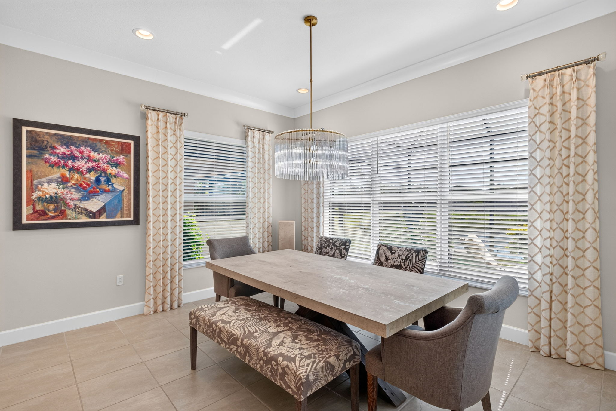 5 windows make this dining area light and bright!Window treatments convey! Statement chandelier present!