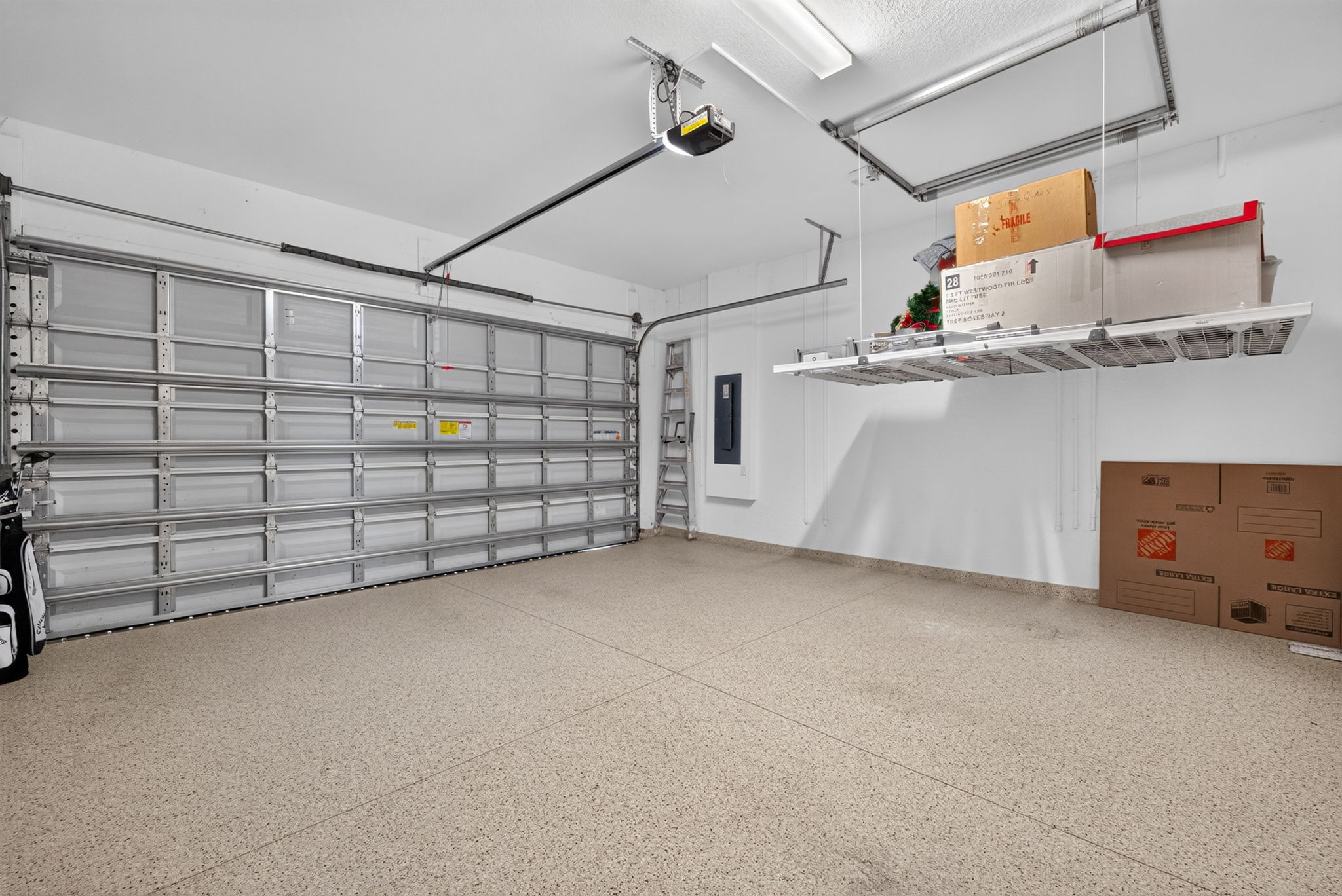 This retractable storage shelf is a lifesaver!!! No ladder required! Upgraded garage flooring.