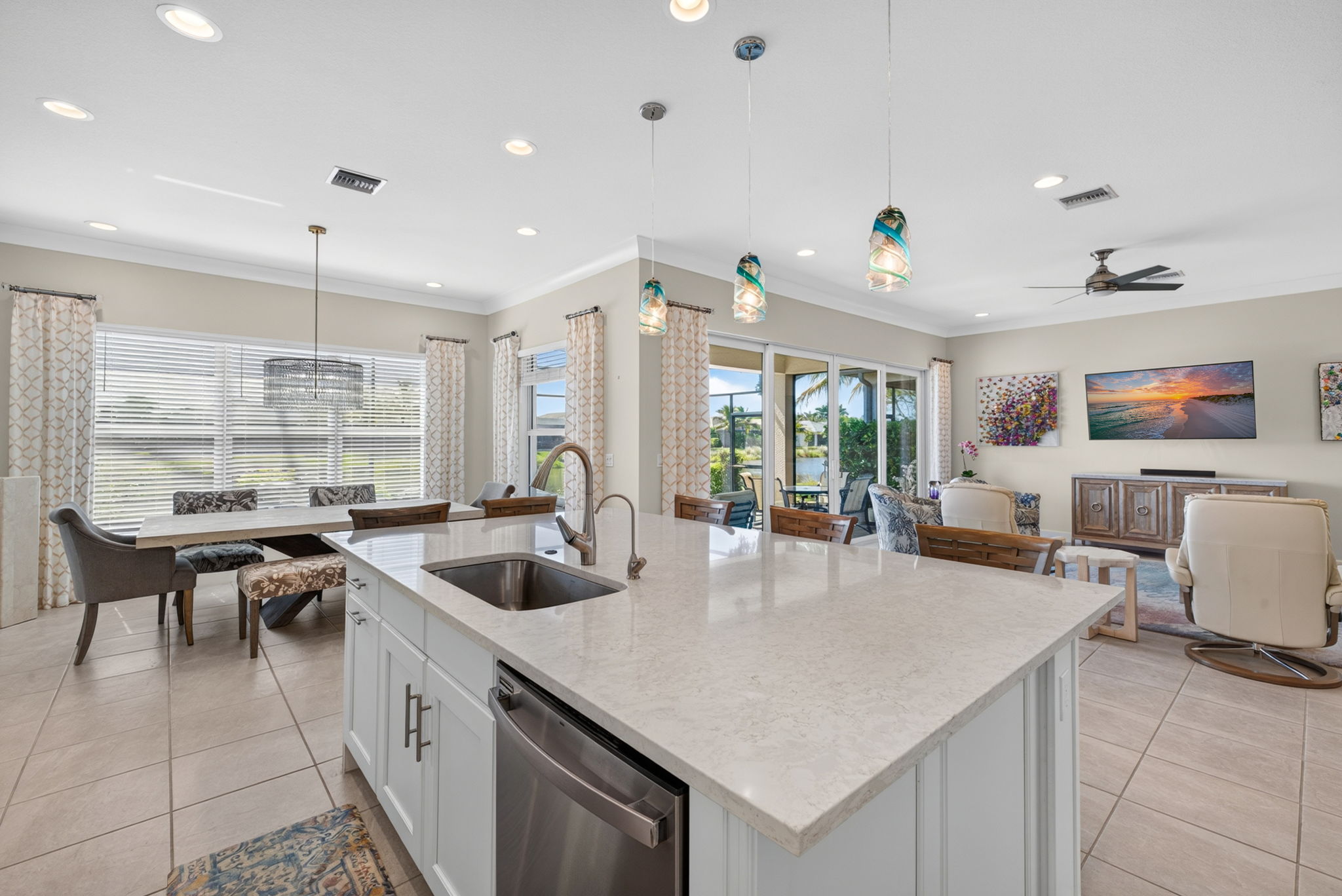 View from kitchen into great room, dining area and outside to take in the awesome lake view!